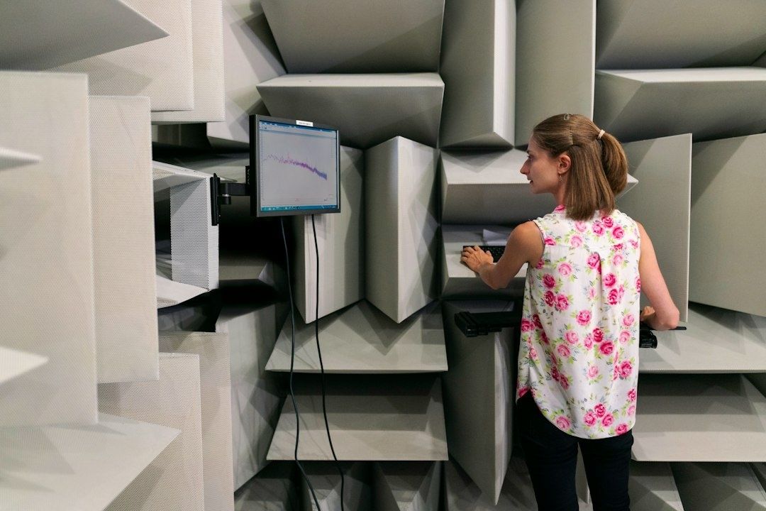 Woman interacting with equipment in a sound-testing room